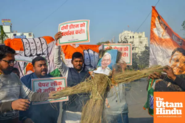 Patna: Youth Congress activists burn an effigy of Bihar Chief Minister Nitish Kumar to protest against the alleged paper leak