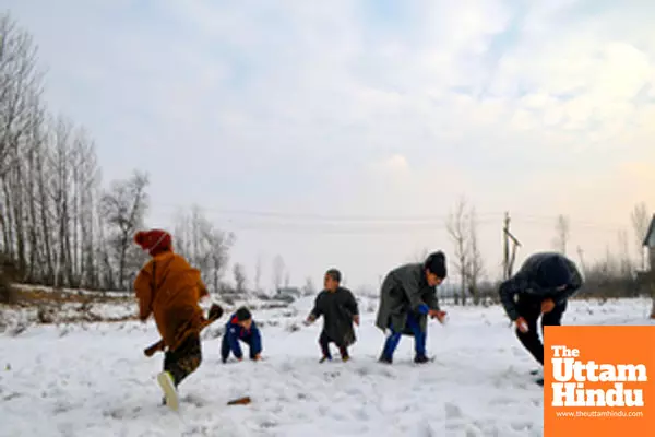 Sopore: Children are seen playing with the snow after a snowfall