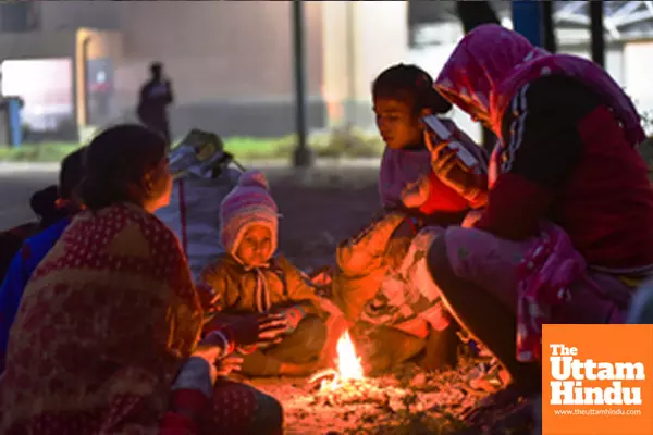 Kolkata: People sit around a bonfire to keep themselves warm on a cold winter evening