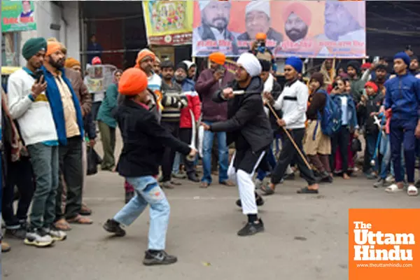 Patna: Devotees perform Gatka (a form of Sikh martial art) during a religious procession