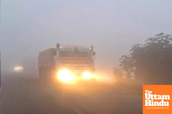 Patna: Vehicles move through dense fog on a chilly winter day