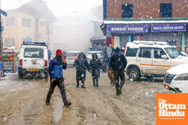 Baramulla: People walk on a snow-covered road as heavy snowfall disrupts daily life