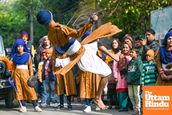 Noida: A Sikh devotee displays Gatka martial art skills during the Nagar Kirtan procession