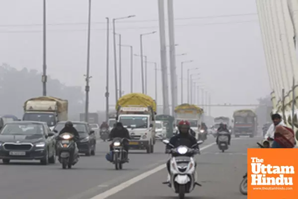 New Delhi: Vehicles navigate through a dense layer of fog, reducing visibility amidst cold weather