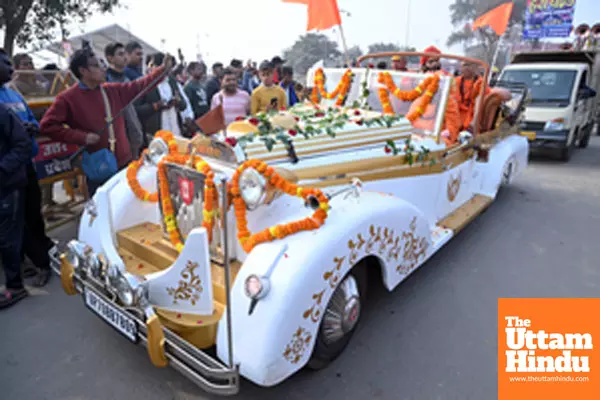 Prayagraj: Sadhus (holy men) arrive in a vintage car ahead of the Maha Kumbh Mela 2025 at Sangam