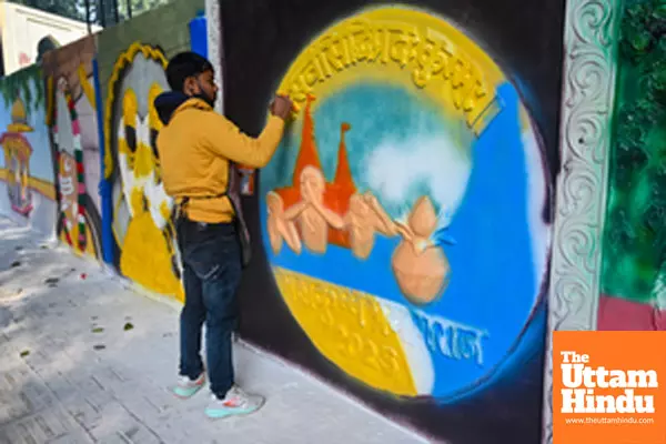 Prayagraj: An artist paints a wall with intricate and vibrant scripture