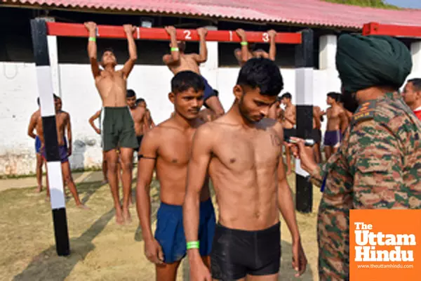 Lucknow: A security personnel writes a number on the chest of an aspirant during an ongoing recruitment drive