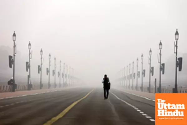 New Delhi: A man walks through dense fog on a cold winter morning