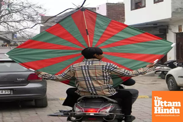 Amritsar: A man on a two-wheeler carries a large kite