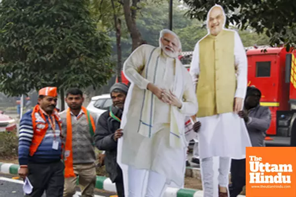 New Delhi: Supporters take cutouts of PM Modi with them after the Jhuggi Basti Pradhan Sammelan programme