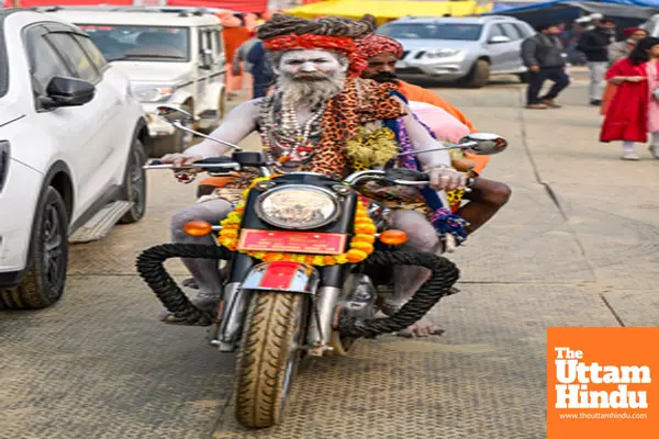 Prayagraj: Sadhus (Holy Men) arrive on a bike at the banks of the Sangam