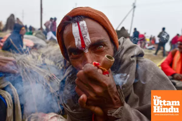 Prayagraj: A Sadhu (Holy Man) smokes a chillum, a traditional clay pipe,