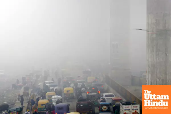 New Delhi: Vehicles navigate through dense fog on a chilly winter morning