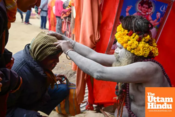 Prayagraj: Devotees seek blessings from a Sadhu (holy man) at the Triveni Sangam