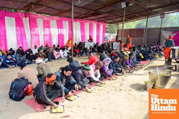 Prayagraj: Devotees eat prasadh at a pandal near Sangam during the Maha Kumbh Mela 2025