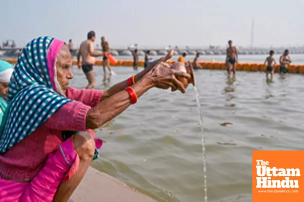 Title : Prayagraj: Devotees perform ritual at the Triveni Sangam