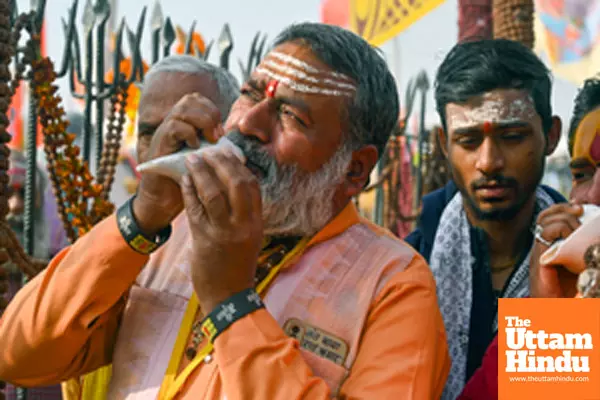 Prayagraj: A man blows a shankh (conch shell) at the Triveni Sangam