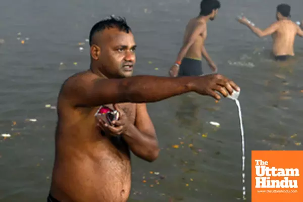 Prayagraj: A devotee takes a holy dip and offers prayers at the Triveni Sangam