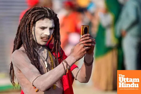 Prayagraj: A sadhu takes a photograph with a mobile phone of newly initiated Naga Sadhus