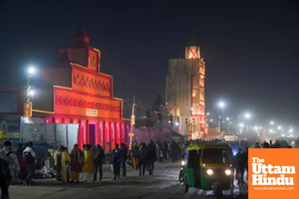 Prayagraj: People stroll near the illuminated entrance at the Maha Kumbh Mela site