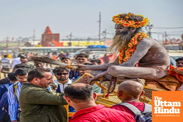 Prayagraj: A devotee seeks blessings from a sadhu at the Sangam during the Maha Kumbh Mela 2025