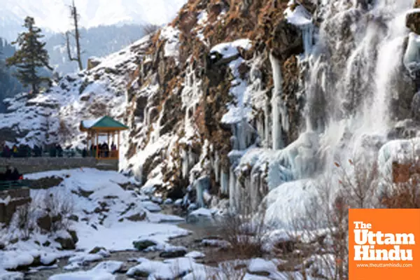 Baramulla: Tourists visit the frozen waterfall in the Drung area of Tangmarg