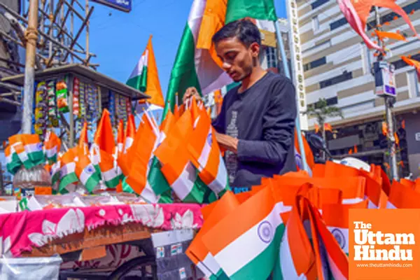 Nagpur: A roadside vendor arranges Indian national flags ahead of Republic Day celebrations