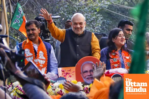 New Delhi: Union Home Minister Amit Shah and BJP MP Bansuri Swaraj participate in a roadshow in support of BJP candidate Neeraj Basoya