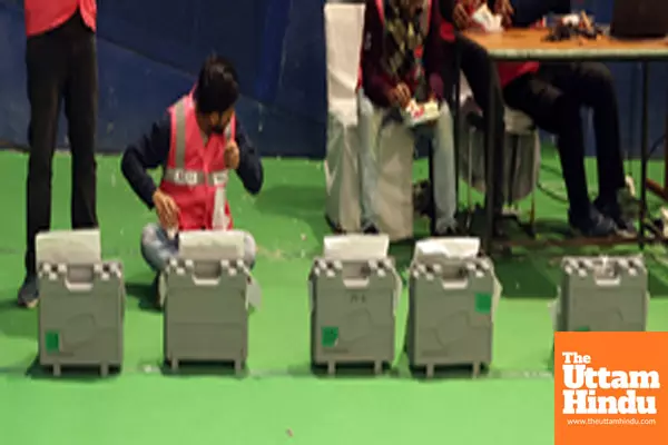 Counting officials tally votes after the Delhi Assembly election