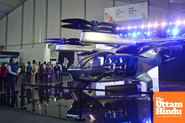 Visitors explore exhibition stalls at Invest Karnataka 2025