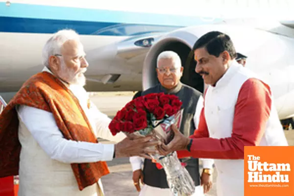 Madhya Pradesh CM Mohan Yadav presents a flower bouquet to PM Modi upon his arrival