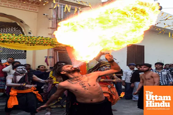 A devotee performs a fire-breathing act during a religious procession on the eve of the Maha Shivratri festival