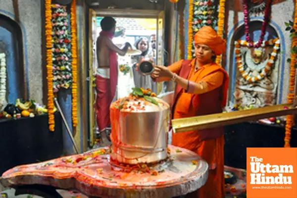 Mahant of Mankameshwar Temple, Divya Giri, offers prayers to Lord Shiva