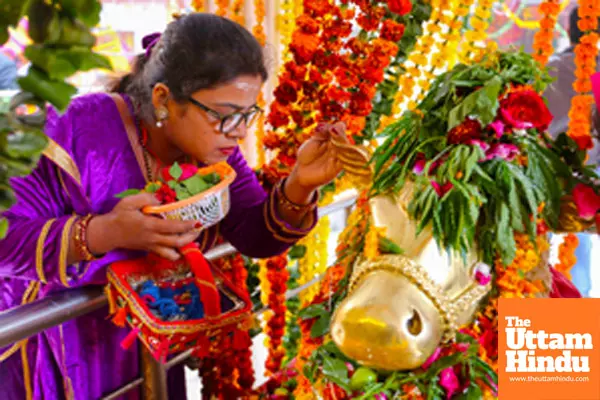 A devotee whispers her wishes in the ears of Nandi